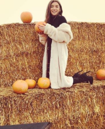 Mimi posing with a pumpkin